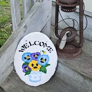 Handpainted "welcome" sign with pansies on slate tile